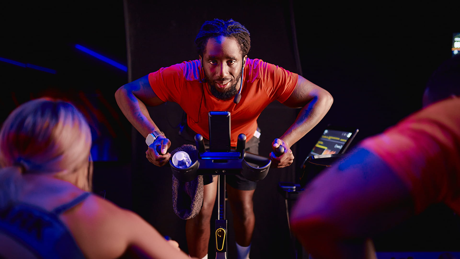 Instructor leading an indoor cycling class