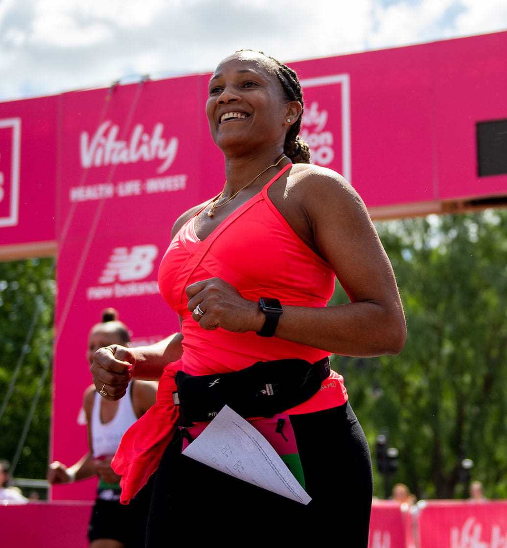 Runners celebrate crossing the finish line of The Vitality London 10,000