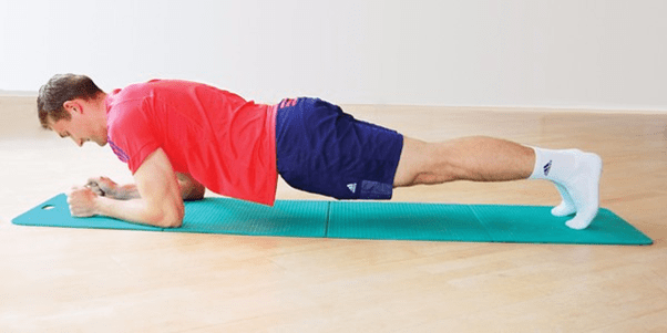 A person lying on a mat with medium confidence doing the plank exercise