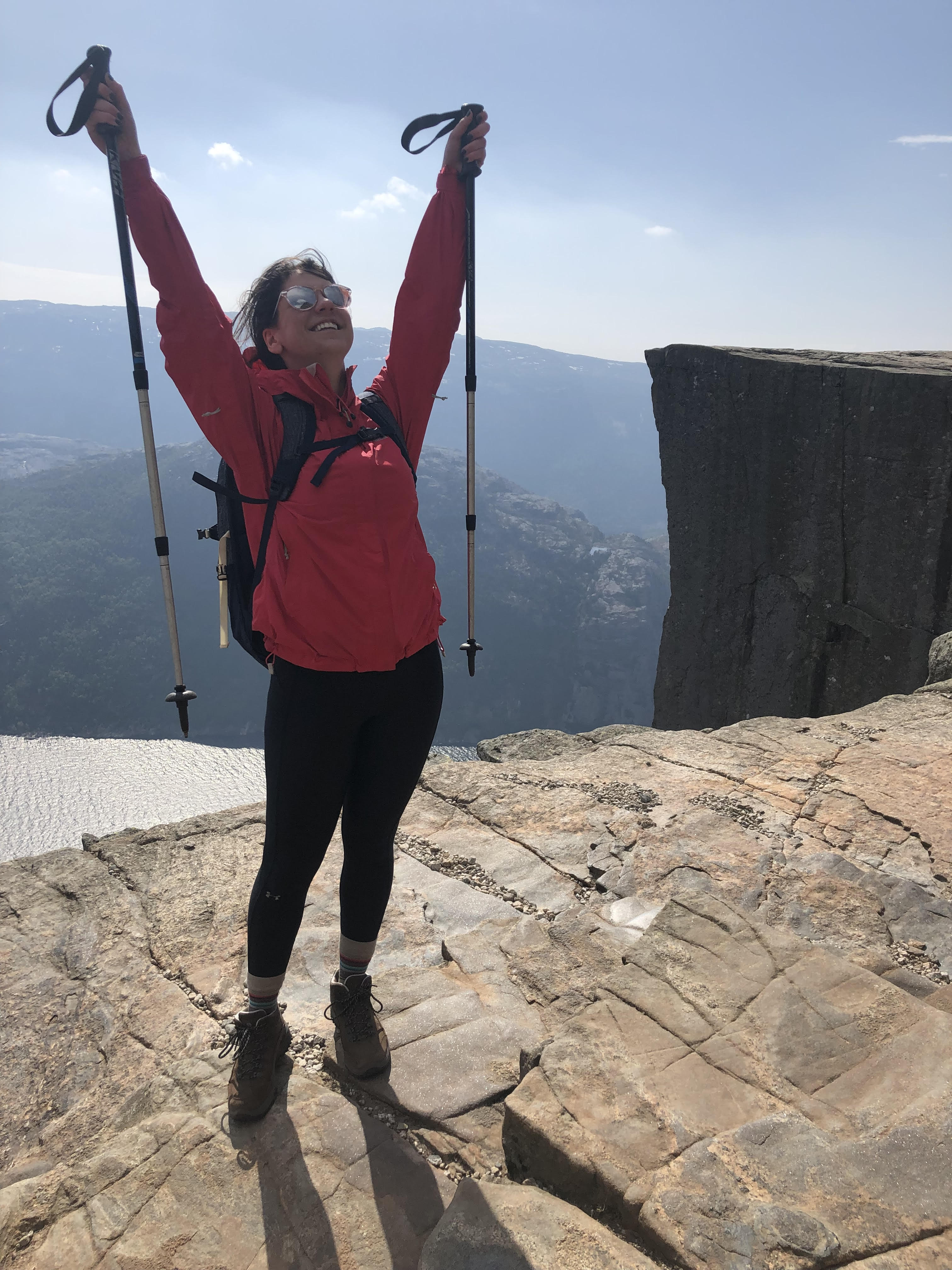 A person standing on top of a mountain with arms in the air