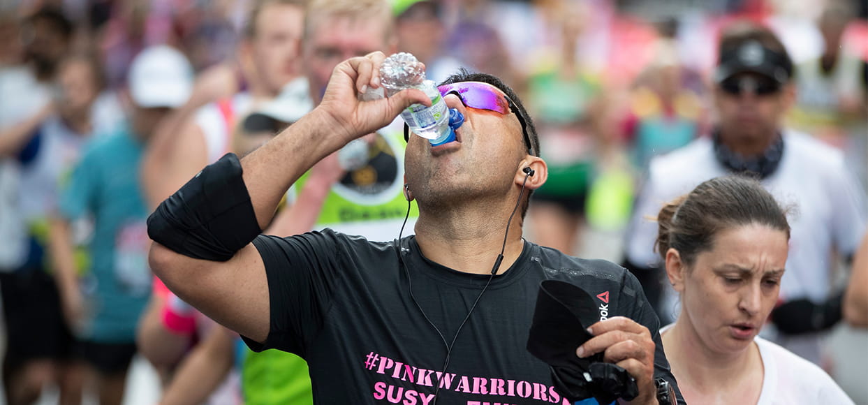 A marathon runner takes a well deserved drink