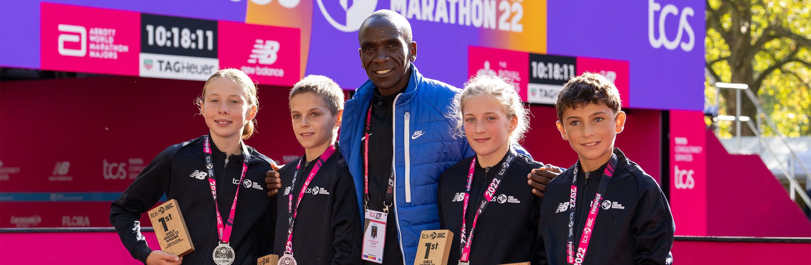 Eliud Kipchoge with winners at the 2022 TCS Mini London Marathon