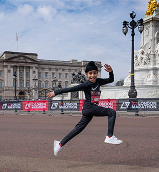 Mini London Marathon participant outside Buckingham Palace
