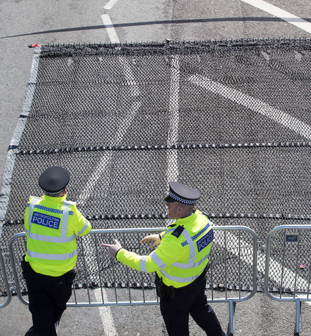 Two policeman guard the road ahead of the 2019 Virgin Money London Marathon