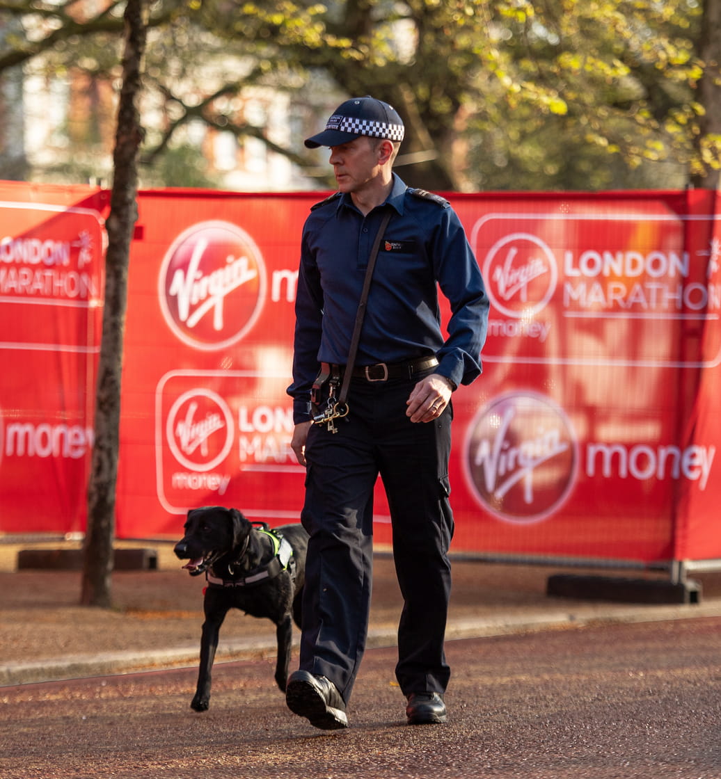 Policeman walks the route with his sniffer dog