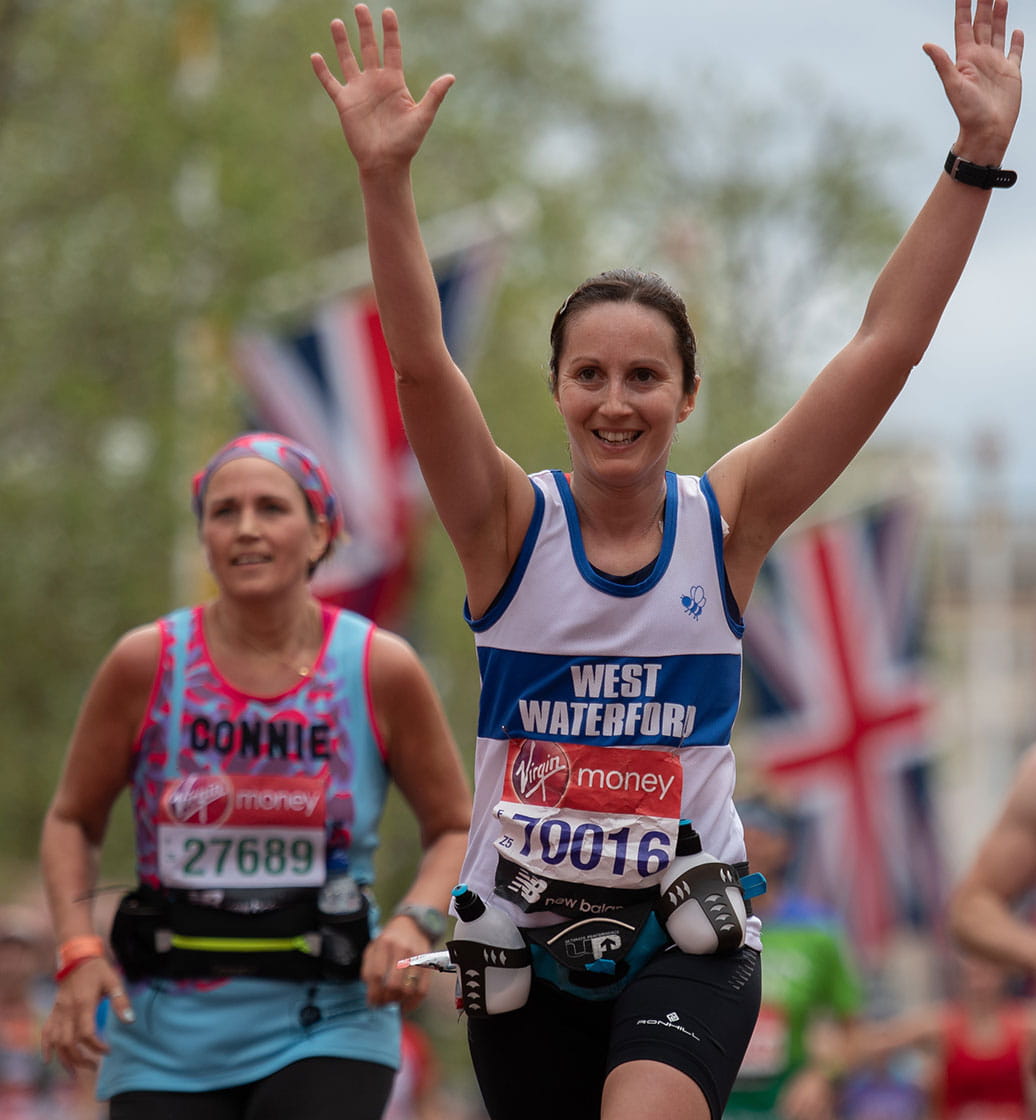 A runner carries her drinks in a bottle belt at the Virgin Money London Marathon