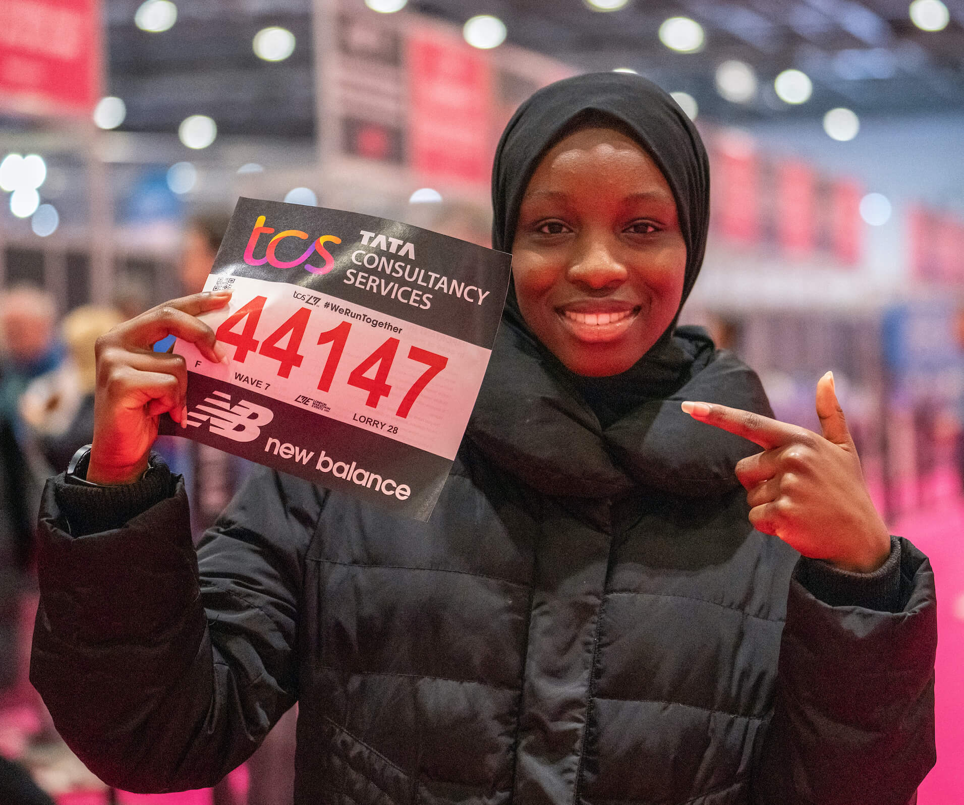 A TCS London Marathon participant holds their bib at the Running Show