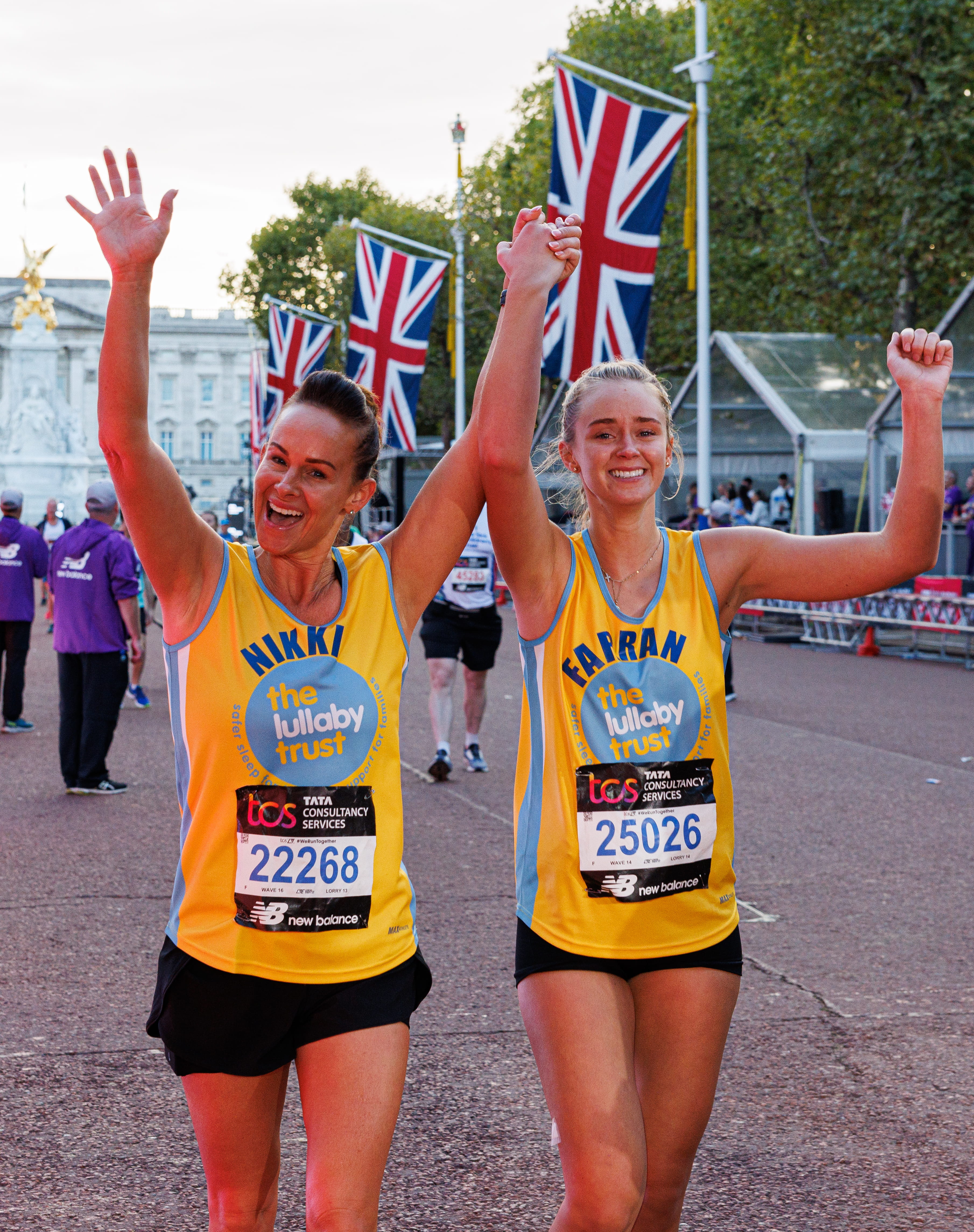 Charity runners head down The Mall holding hands