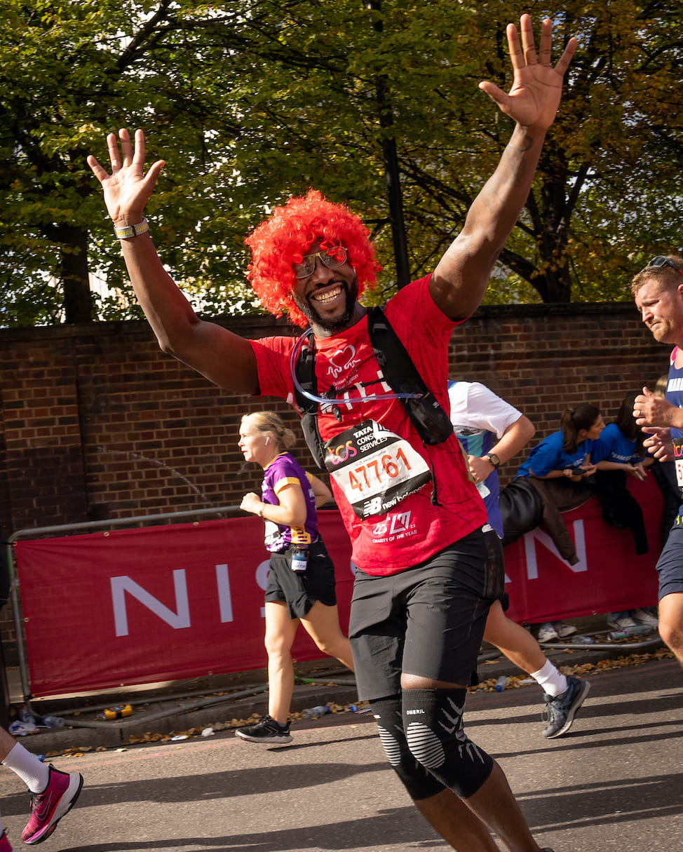 A TCS London Marathon participant with their hands in the air
