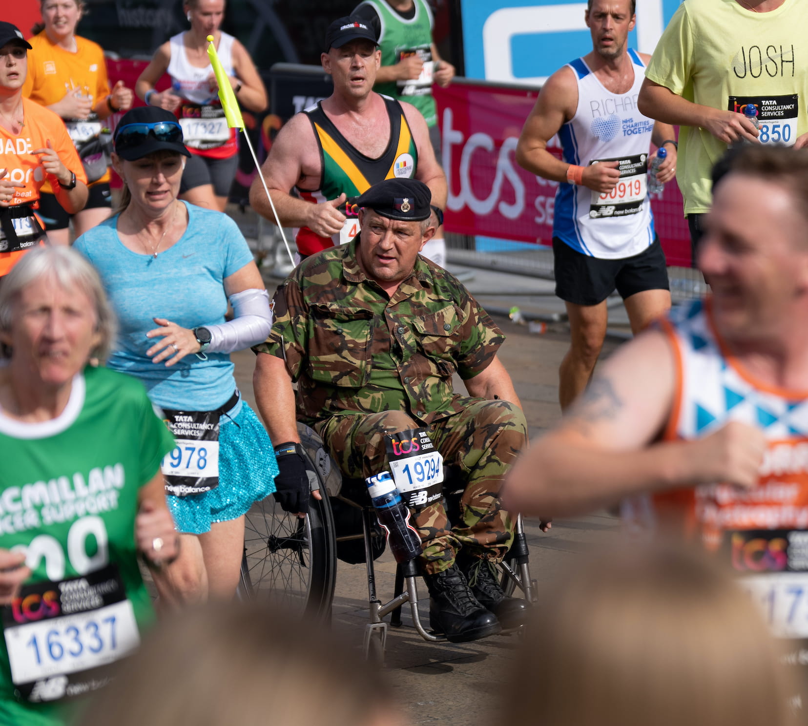 A wheelchair TCS London Marathon participant wearing military uniform