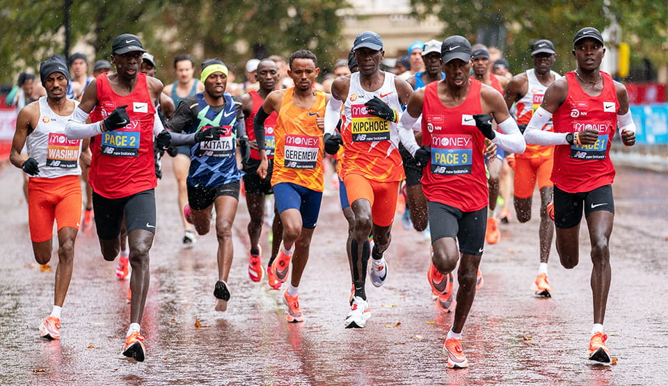Mosinet Geremew (ETH) and Eliud Kipchoge (KEN) are tucked in behind the pace runners