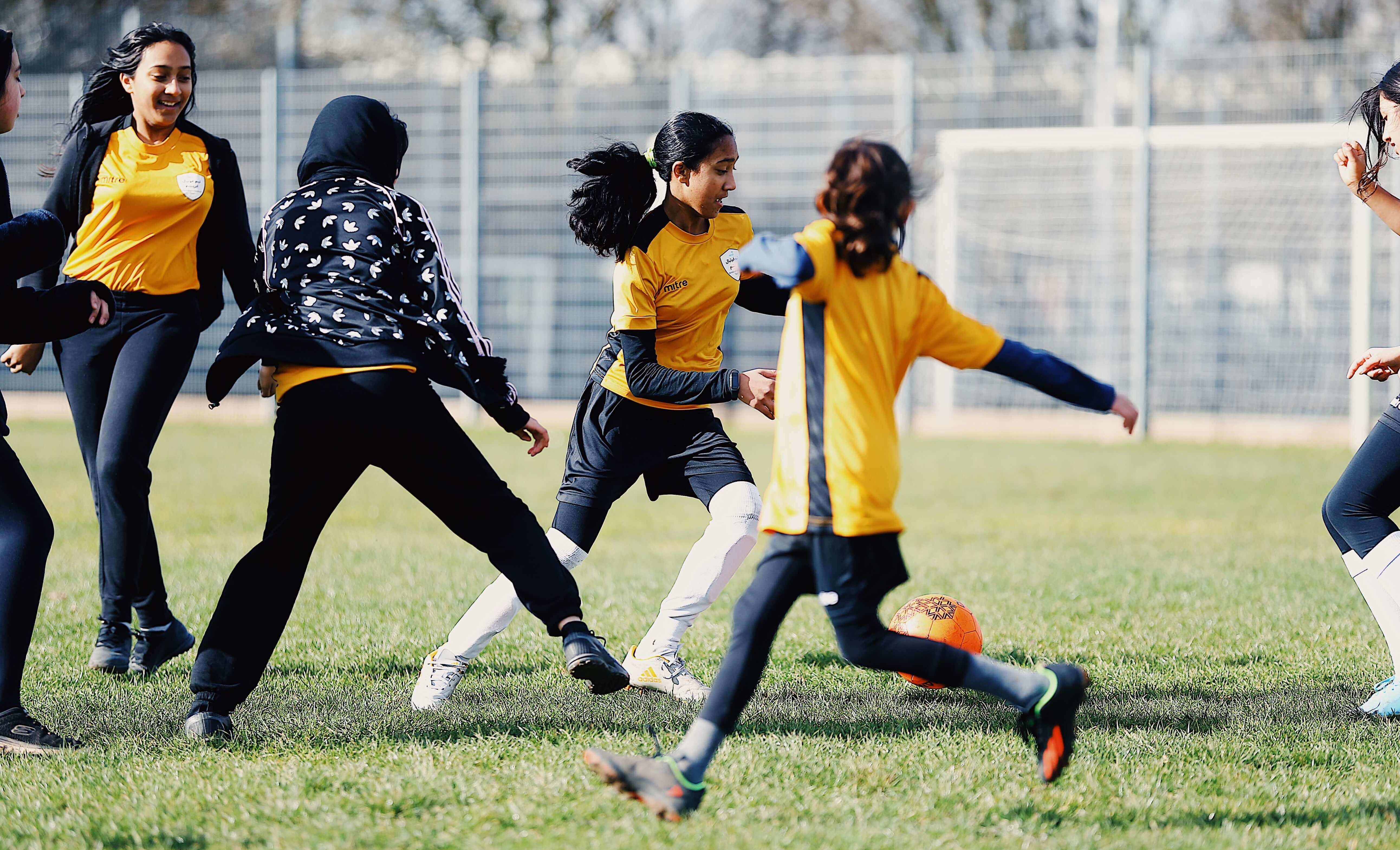 A group of girls playing football