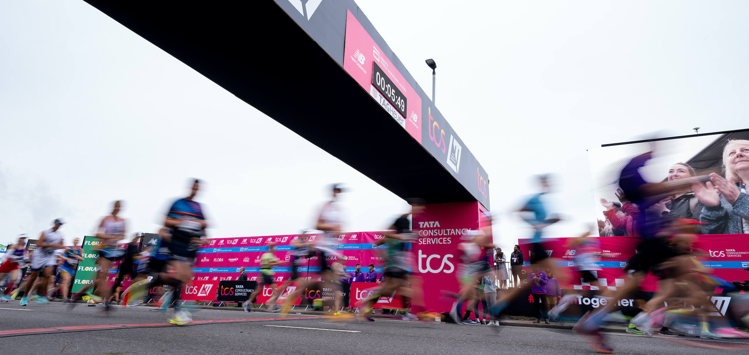 A blur of participants crossing the Start Line