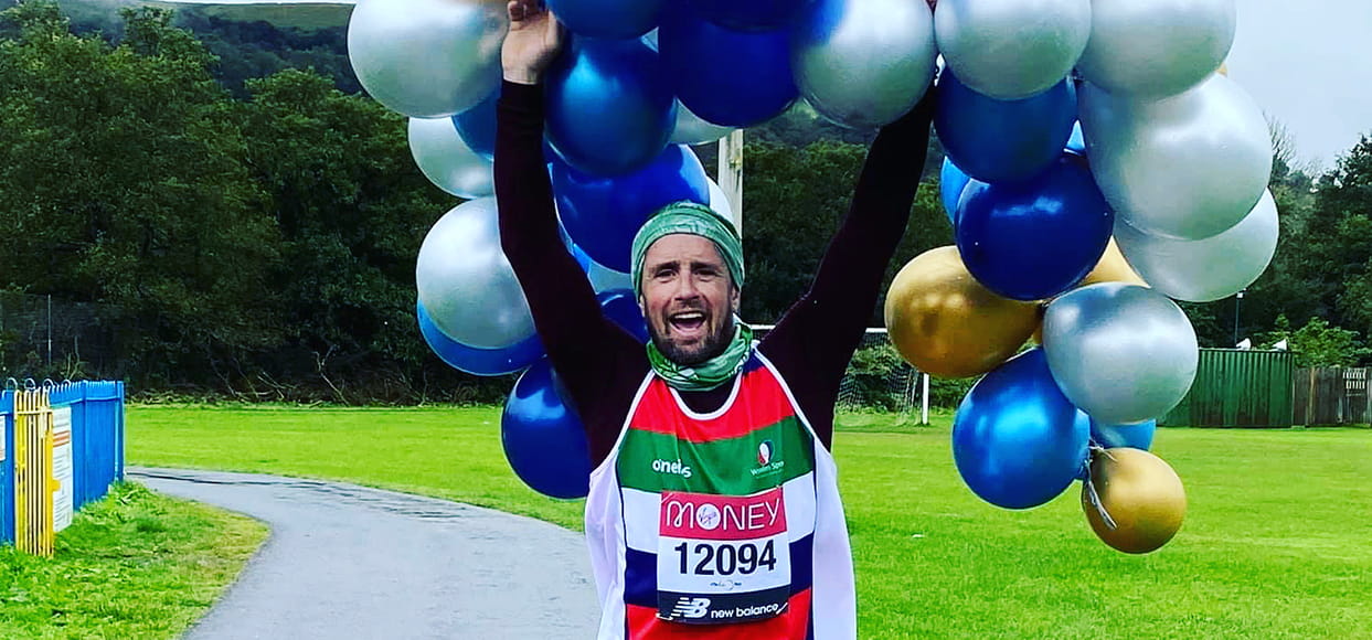 A virtual Virgin Money London Marathon runner celebrates after completing his run