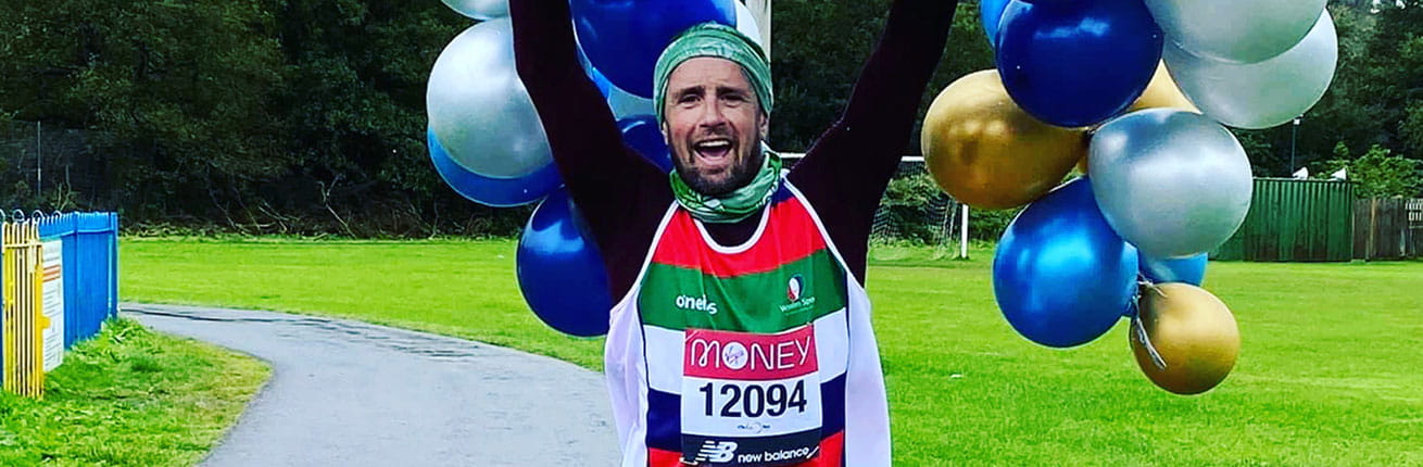 A virtual Virgin Money London Marathon runner celebrates after completing his run