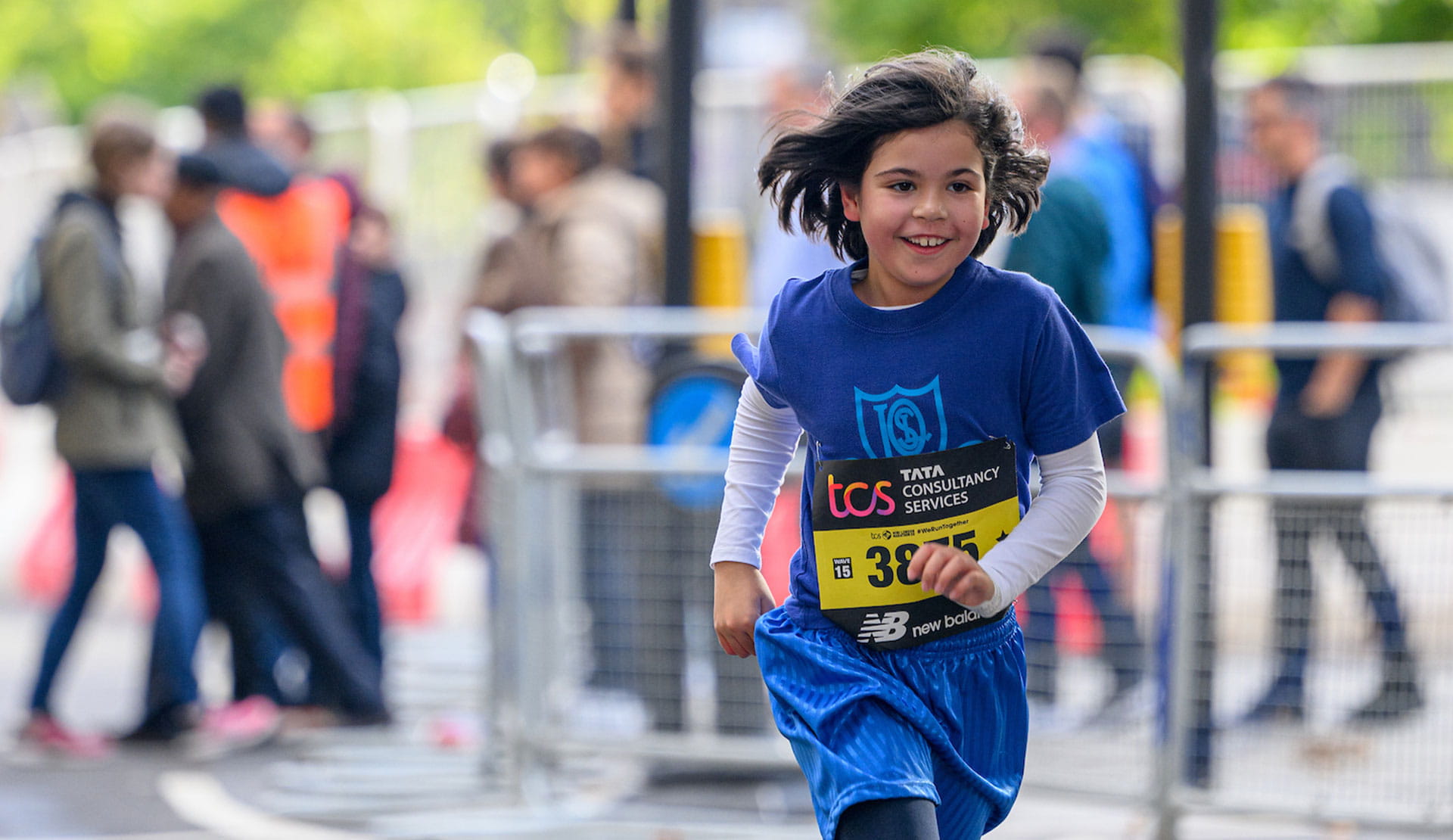 A young competitor in the race runs down The Mall during The TCS Mini London Marathon on Saturday 1st October 2022