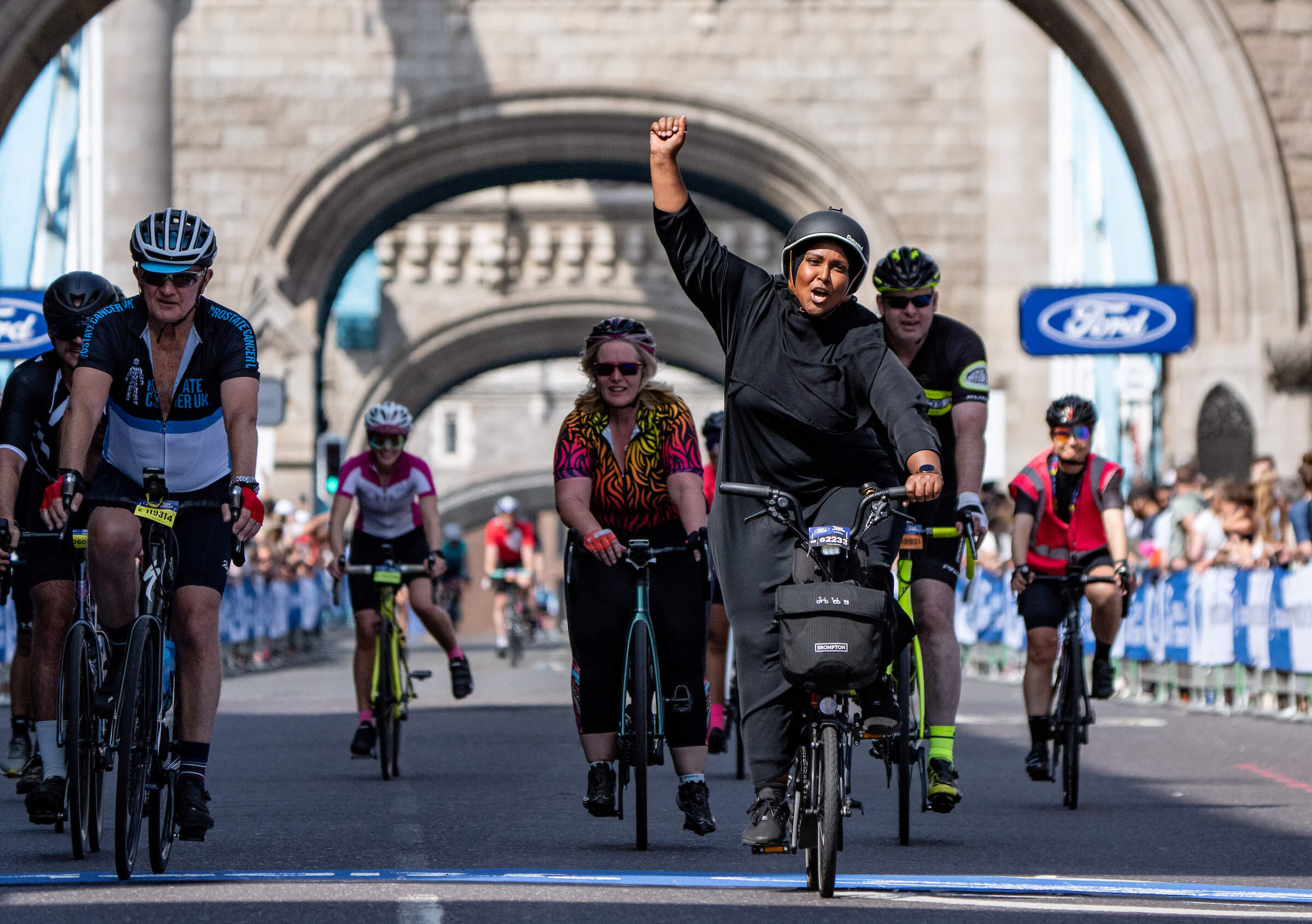 Triumphant cyclists at Tower Bridge