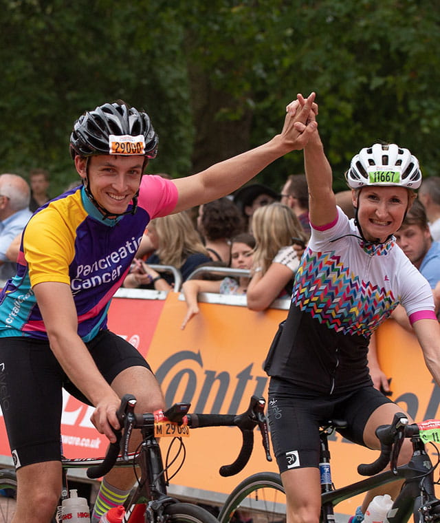 Cyclists celebrating as they cross the finish line at the end of the The RideLondon Sportives
