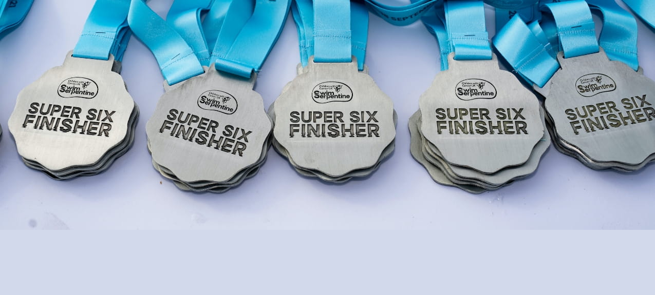 Detail of the Super Six Finisher medals at the Children With Cancer UK Swim Serpentine on Saturday 18th September 2021.