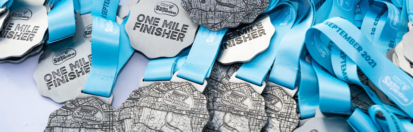 Detail of the One Mile Finisher medals at the Children With Cancer UK Swim Serpentine on Saturday 18th September 2021.