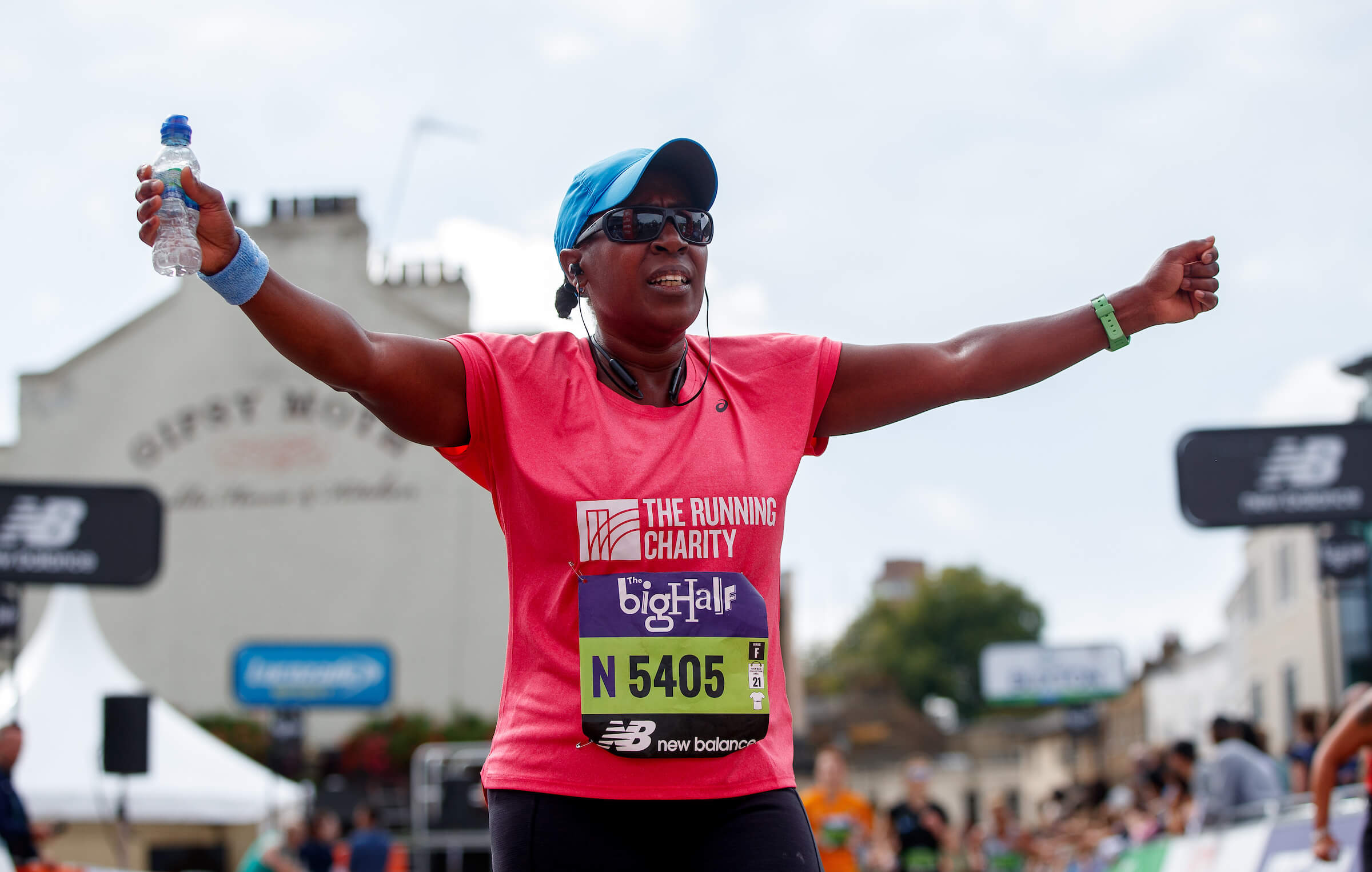 A participant running The Big Half with arms outstretched