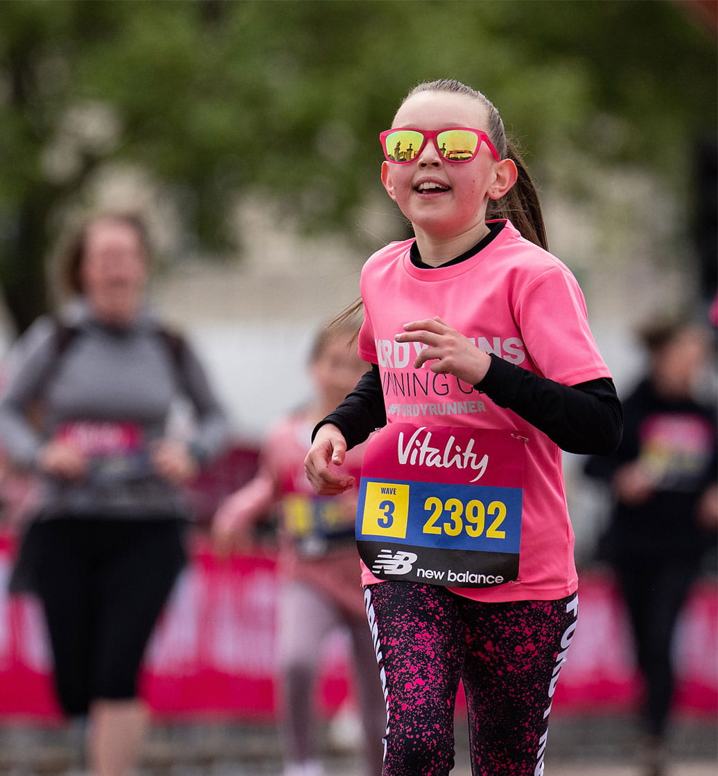 A young runner sprints towards the finish line on The Mall.