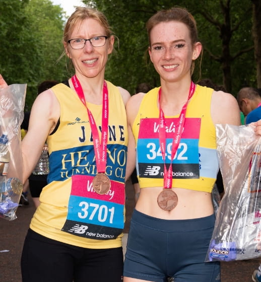 Runners pose with their goody bags after they complete The Vitality London 10,000