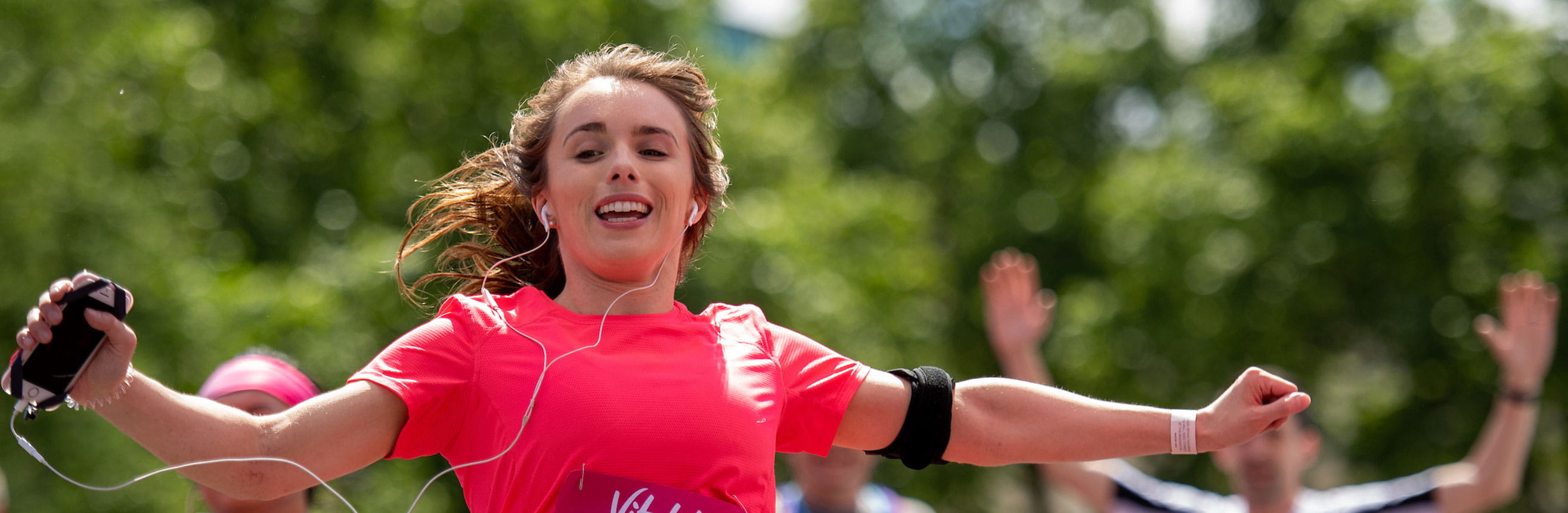 Runners celebrate as they approach the finish line of The Vitality London 10,000