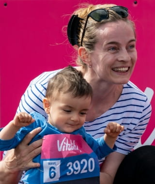 A parent and child at the finish line looking very happy