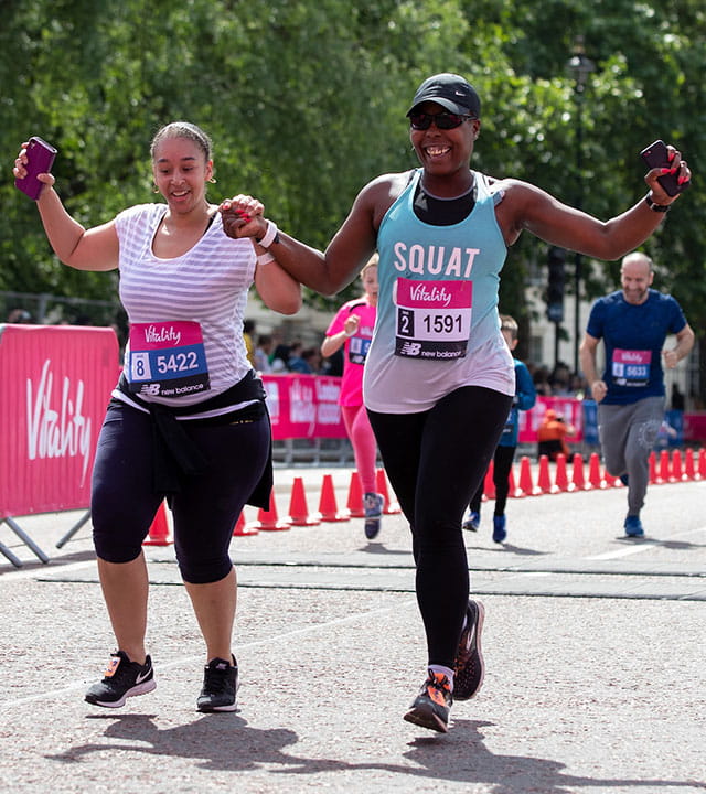 Runners celebrate crossing the finish line of The Vitality Westminster Mile